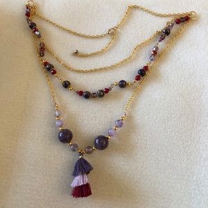 Layered necklace with a boho theme.